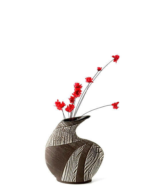 Decorative vase with red flowers on a white background