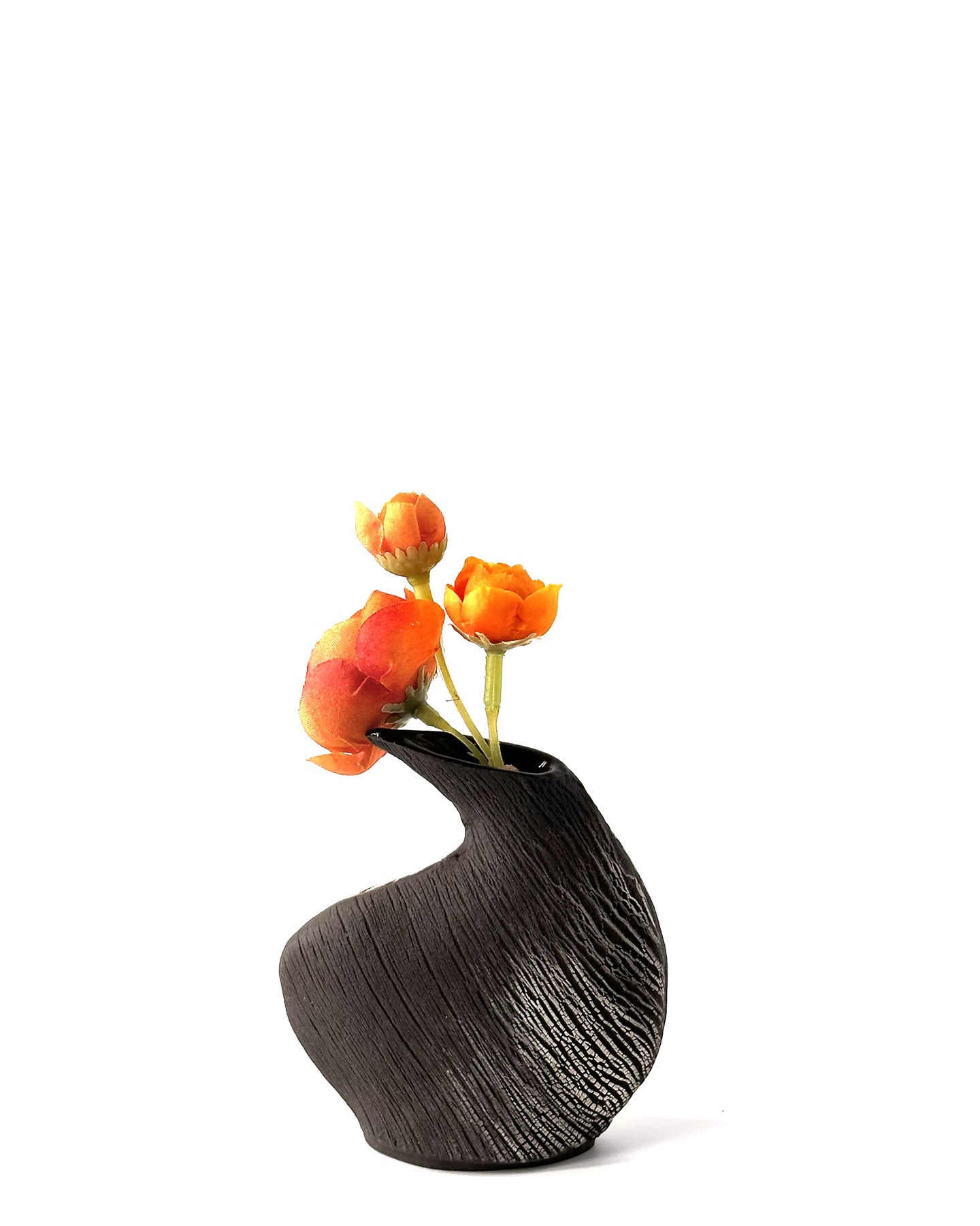 Black textured vase with orange flowers on a white background