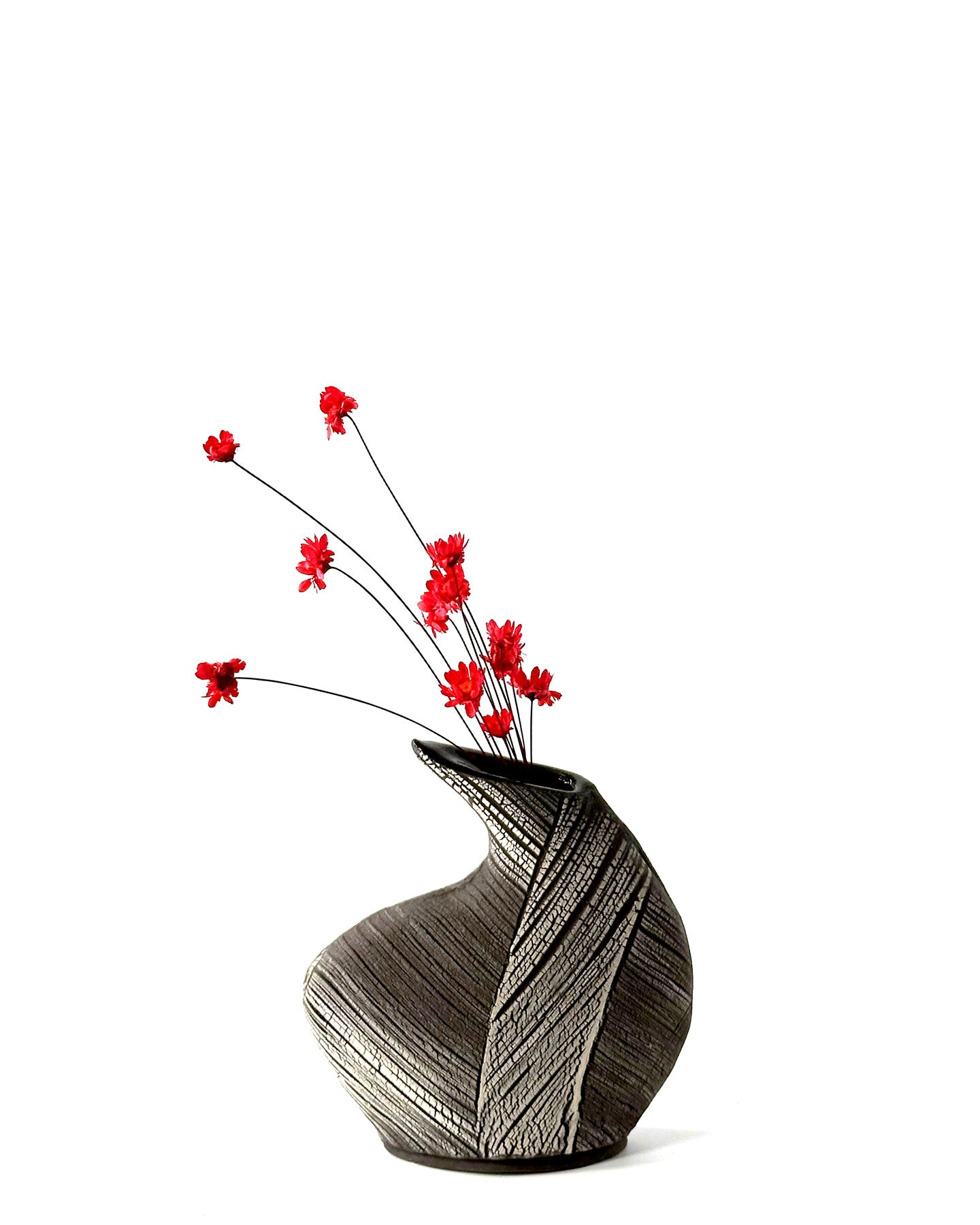 Decorative vase with red flowers on a white background