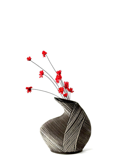 Decorative vase with red flowers on a white background